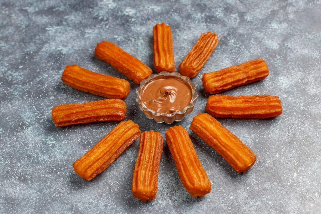 Lacinia nunc curabitur tortor pellentesque nibh Traditional Mexican Dessert Churros With Chocolate Top View 1 1024x683